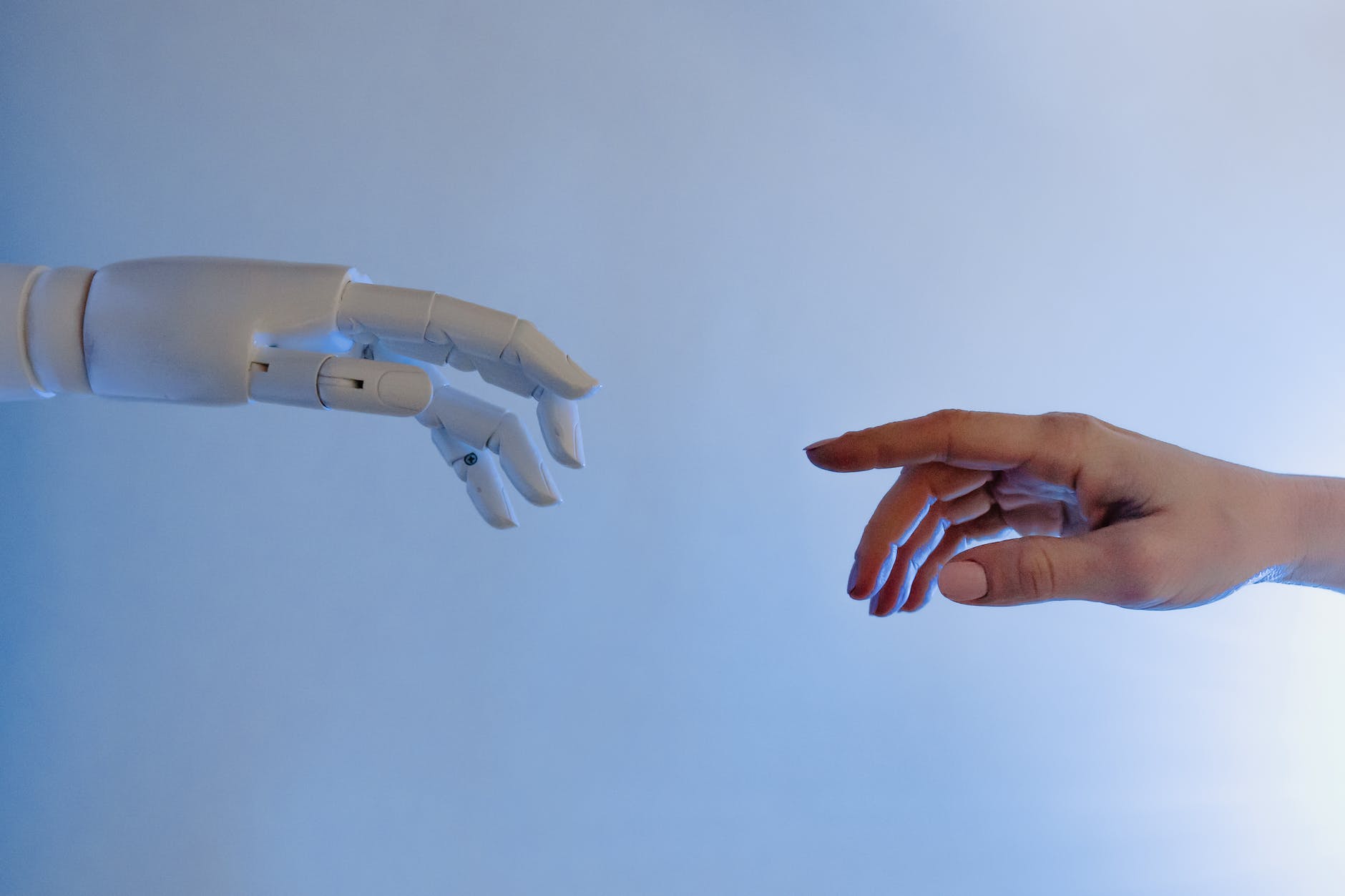 person reaching out to a robot